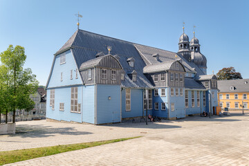 Clausthal-Zellerfeld, Germany – August 28, 2024: People resting at the Market Church of the Holy Spirit, Germany's biggest wooden church. It is popular among tourists and built between 1639 and 1642.