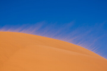 Wind blowing sand dunes in Utah.