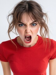 An angry woman stares directly at the camera with an intense expression. Her furrowed brows and tense posture convey frustration, determination, or defiance.