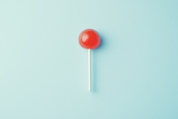 A Red Round Lollipop Lies On A Pale Blue Background