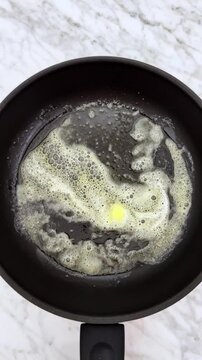 Melting butter on hot frying pan