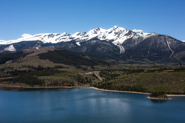 Snow capped mountains over a lake in Colorado.