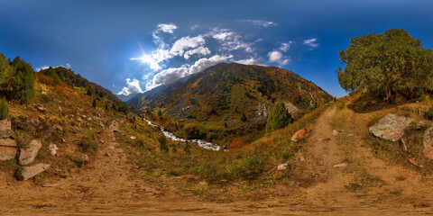 Full Spherical panorama of rocky hiking trail trough picturesque mountain valley at sunny autumn...