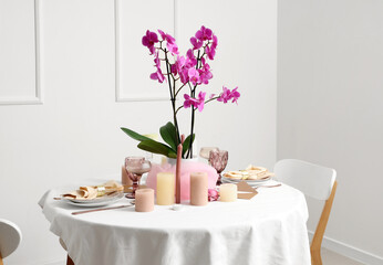 Beautiful table setting with orchid flower for wedding celebration in room
