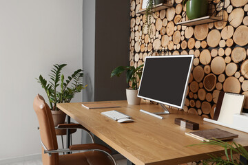 Fototapeta premium Workplace with computer and plants in office