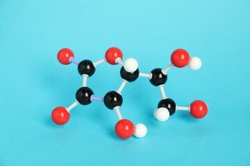 Molecule of vitamin C on light blue background. Chemical model