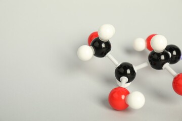 Molecule of vitamin C on light grey background, closeup and space for text. Chemical model