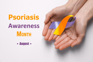Psoriasis Awareness Month (August). Woman holding orange-orchid awareness ribbon on white background, top view