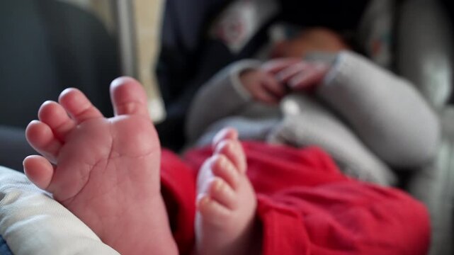 Newborn resting in car seat, tiny feet in foreground, soft and tender toes, relaxed and peaceful atmosphere, close-up shot highlighting baby&rsquo;s cozy and comfortable rest, intimate and loving moment