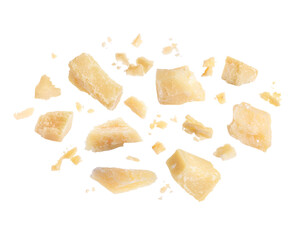 Pieces of delicious parmesan cheese flying on white background