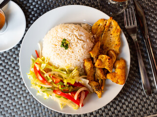 Stewed chicken with rice and fresh vegetable salad - Latin American cuisine