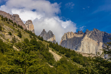 Torres del Paine tower mountain granite peaks in the Andes. Patagonia mountains beautiful landscape with blue sky and no clouds. Trekking and hiking in Patagonia Andes watching stunning rocks and lake