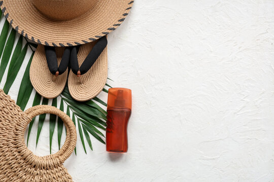 Beautiful composition with beach accessories and sunscreen on white background
