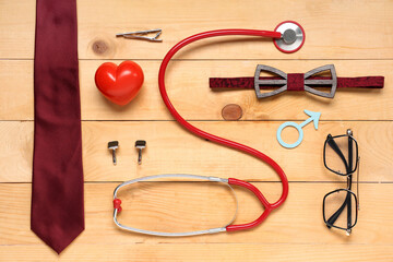 Tie, stethoscope, heart and male sign on wooden background. Prostate cancer awareness