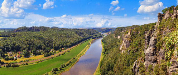 Obraz premium Beautiful landscape, panorama, banner - view of the Elbe valley near the village of Rathen in the Elbe Sandstone Mountains, in Saxony, Germany