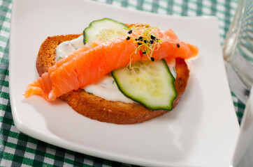 Homemade sandwich with smoked salmon, cucumber and garlic sauce