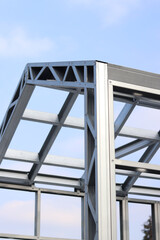 Obraz premium Lightweight steel thin-walled structures. Frames for warehouses, garages or houses. Structure of a steel frame for construction against the sky