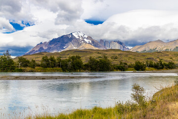 Torres del Paine tower mountain granite peaks in the Andes. Patagonia mountains beautiful landscape with blue sky and no clouds. Trekking and hiking in Patagonia Andes watching stunning rocks and lake