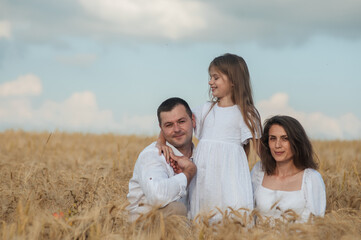 The concept of a friendly family.Cool photo session in a field