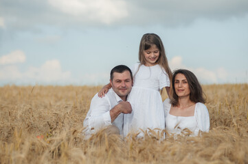 The concept of a friendly family.Cool photo session in a field