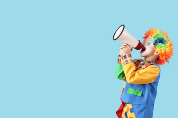 Funny little boy dressed as clown with megaphone on blue background. April Fool's Day celebration