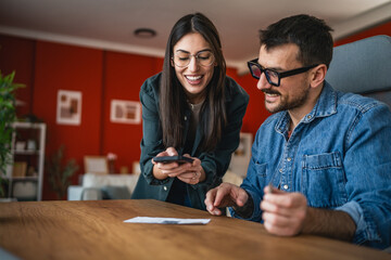 man and woman couple pay bills at home have contactless payment