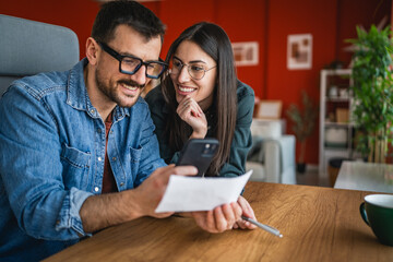 man and woman couple pay bills at home have contactless payment