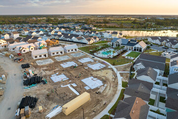Development of residential housing in the USA. Wooden frames of new cheap American homes under...