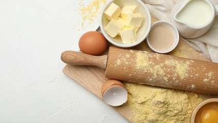 Rolling pin and different ingredients on white table, flat lay. Space for text