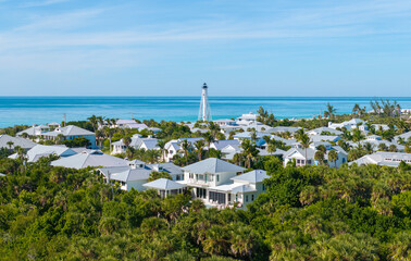 Large residential homes and tall lighthouse in island small town Boca Grande on Gasparilla Island...