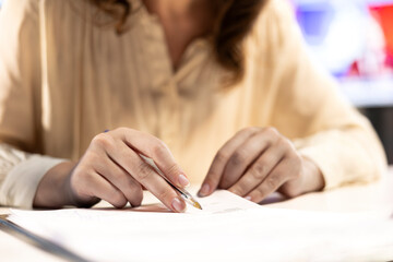 Female CEO solving her business paperwork tasks and signing documents, approving requests from...