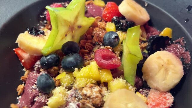 Carambola is a bright star in the world of exotic fruits blackberry raspberry banana carambola strawberry nuts lokhina blueberry delicious fruit dessert fruit salad on black plate