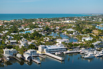 Fototapeta premium Wealthy waterfront residential area. Rich neighborhood with expensive vacation homes in Boca Grande, small town on Gasparilla Island in southwest Florida