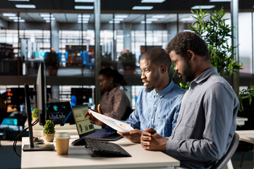 Corporate team members gathered around a table in the office, focusing on achieving company objectives, performance metrics, and strategic business solutions to drive sustained organizational growth.