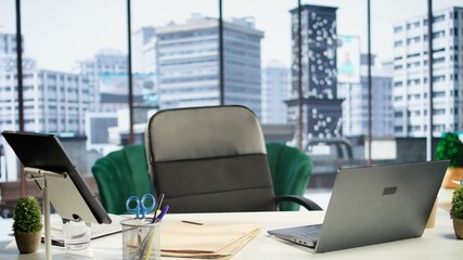 Empty modern corporate high end office space designed for a leader or person with authority, running analytics and reports on screen. Urban global enterprise workspace, empowerment.