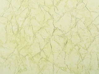 Pale green textured background with a cracked and creased surface. Suitable for wallpaper or design projects.