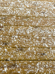 Fresh snowflakes on a wooden deck