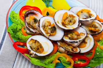 Baked in oven European bittersweet clams served with boiled potatoes, fresh vegetables and greens