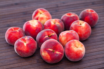 Fresh organic peaches on wooden background, fruit vegan food