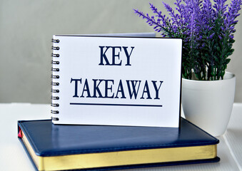 KEY TAKEAWAY - words in a notebook against the background of a diary and lavender