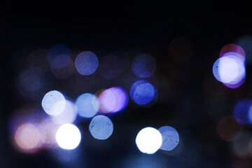 Colorful defocused bokeh lights in blur night background. Vintage tone.