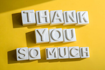 Thank You So Much in bold white block letters on vibrant yellow background with strong shadows and contrast