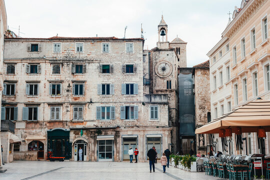 Historic stone building with a clock tower in a European city square, old architecture. Peoples Square Narodni trg in Split, Croatia