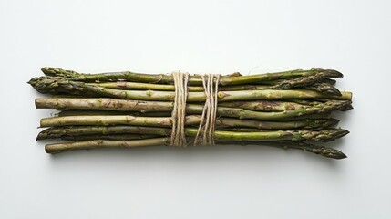 A bunch of fresh green asparagus tied with twine, ready for cooking.