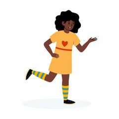 Cheerful girl in a yellow dress with heart design and striped socks waving happily
