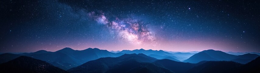 Starlit night over mountain range showcases the beauty of the Milky Way and serene landscape