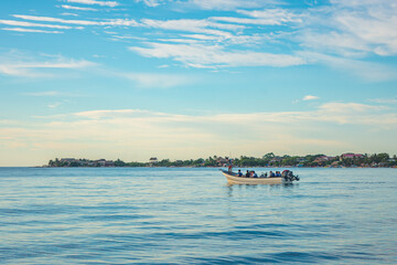Fototapeta premium Scenic view of a boat in Rincon del Mar, Sucre, Colombia with serene waters and blue sky