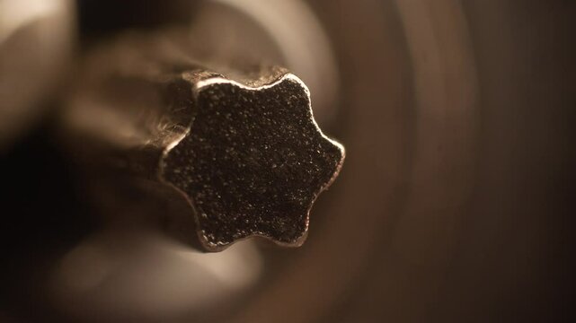 Macro image of a rotating Torx bit on a power screwdriver. Close-up of a special screw tip used for furniture assembly