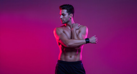 Fototapeta premium Muscular man warming up by stretching his arms, posed in a colored studio setting with a vibrant pink background. Highlighting fitness dedication, athletic lifestyle, and health commitment
