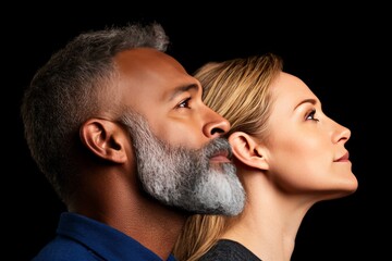Fototapeta premium Close up profile of a mature bearded man and young blonde woman facing opposite directions symbolizing generational contrast introspection and human duality